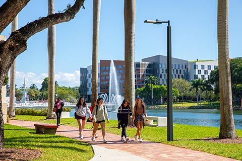 Students walking on campus by the lake
