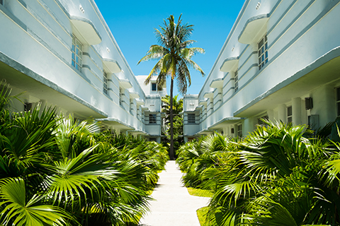 This is a stock photo. A courtyard at a Miami Beach apartment community.